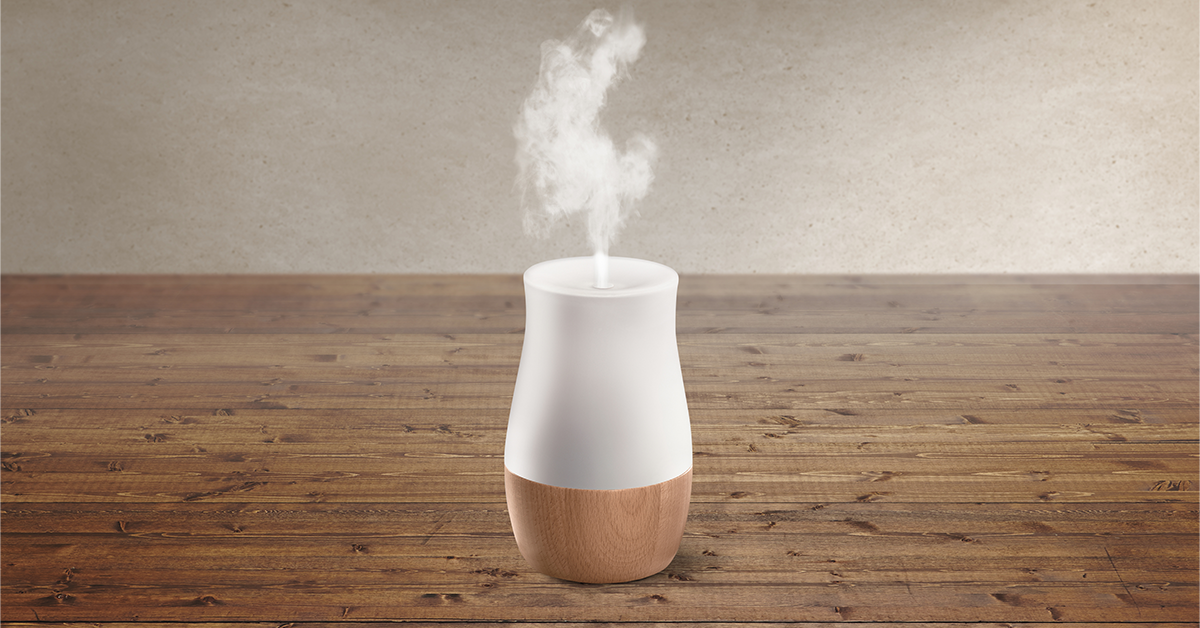 Oil diffuser on top of a desk blowing steam 